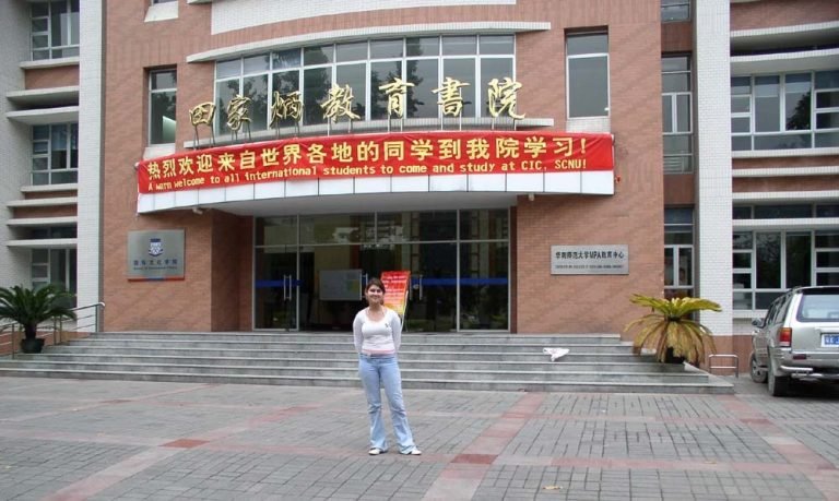 a woman standing in front of a building