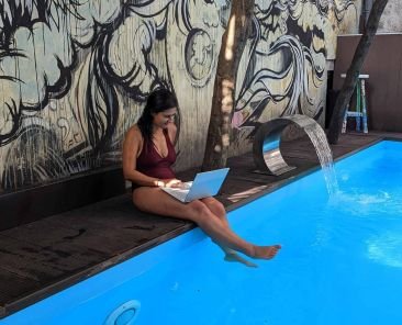 A woman with her online job by the pool