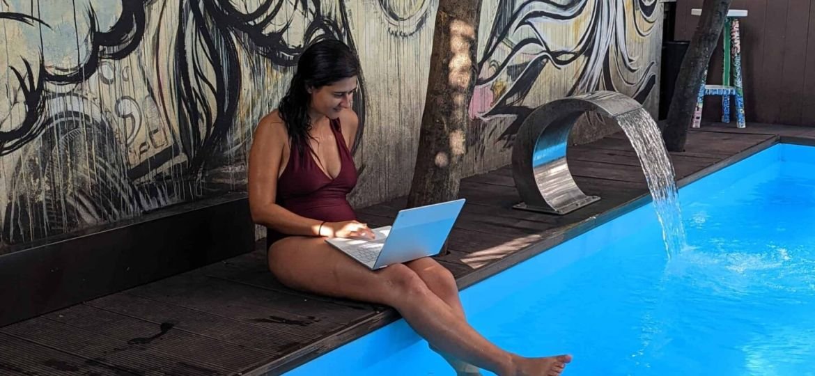 A woman with her online job by the pool