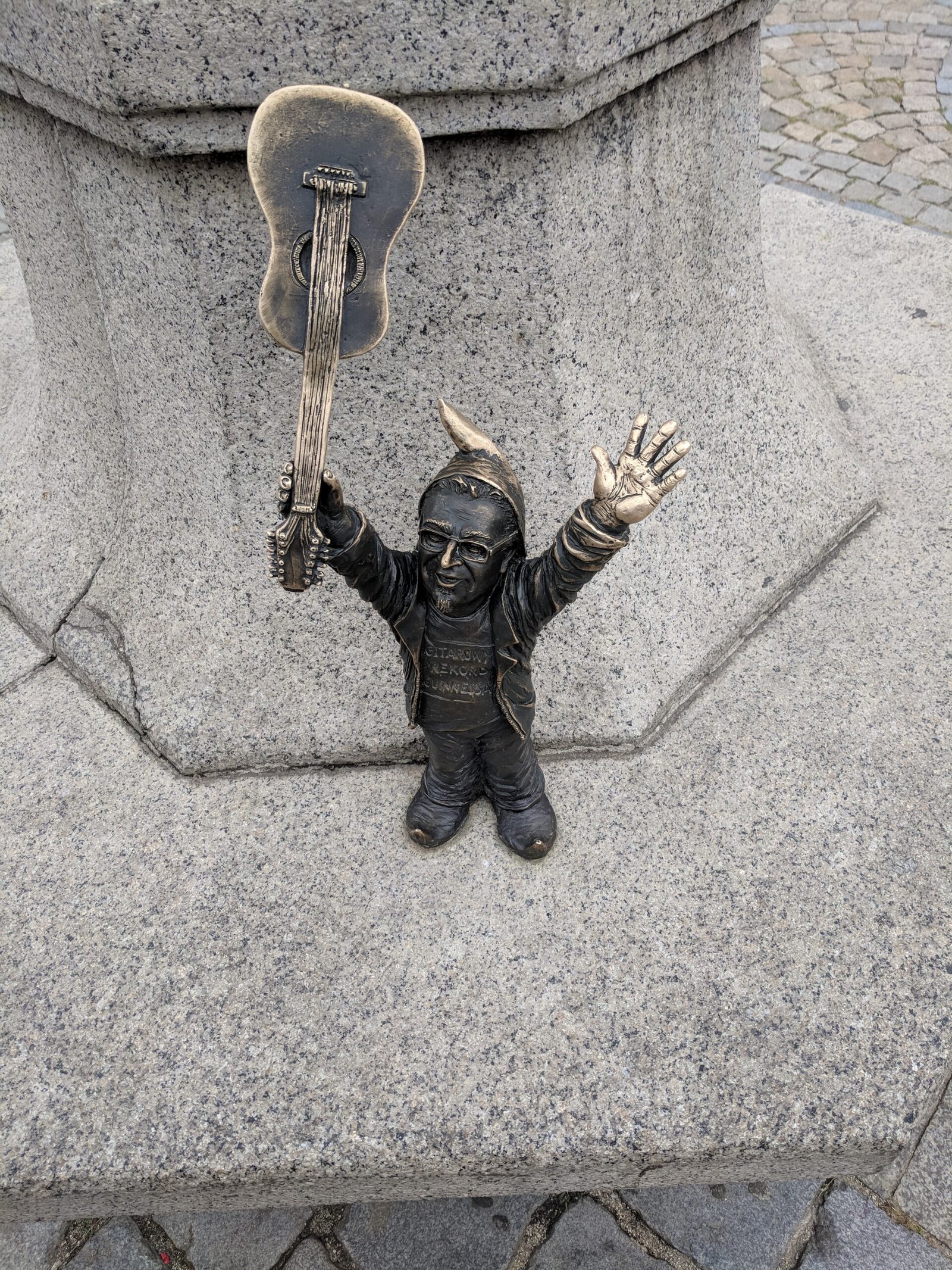 a 3-day itinerary in wrocław | a statue of a dwarf holding a guitar
